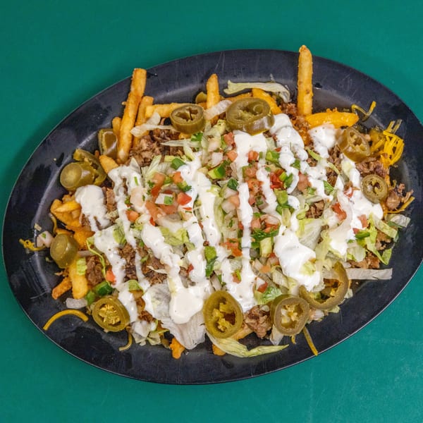 Loaded fries with seasoned meat, lettuce, pico de gallo, creamy sauce, and jalapeños.